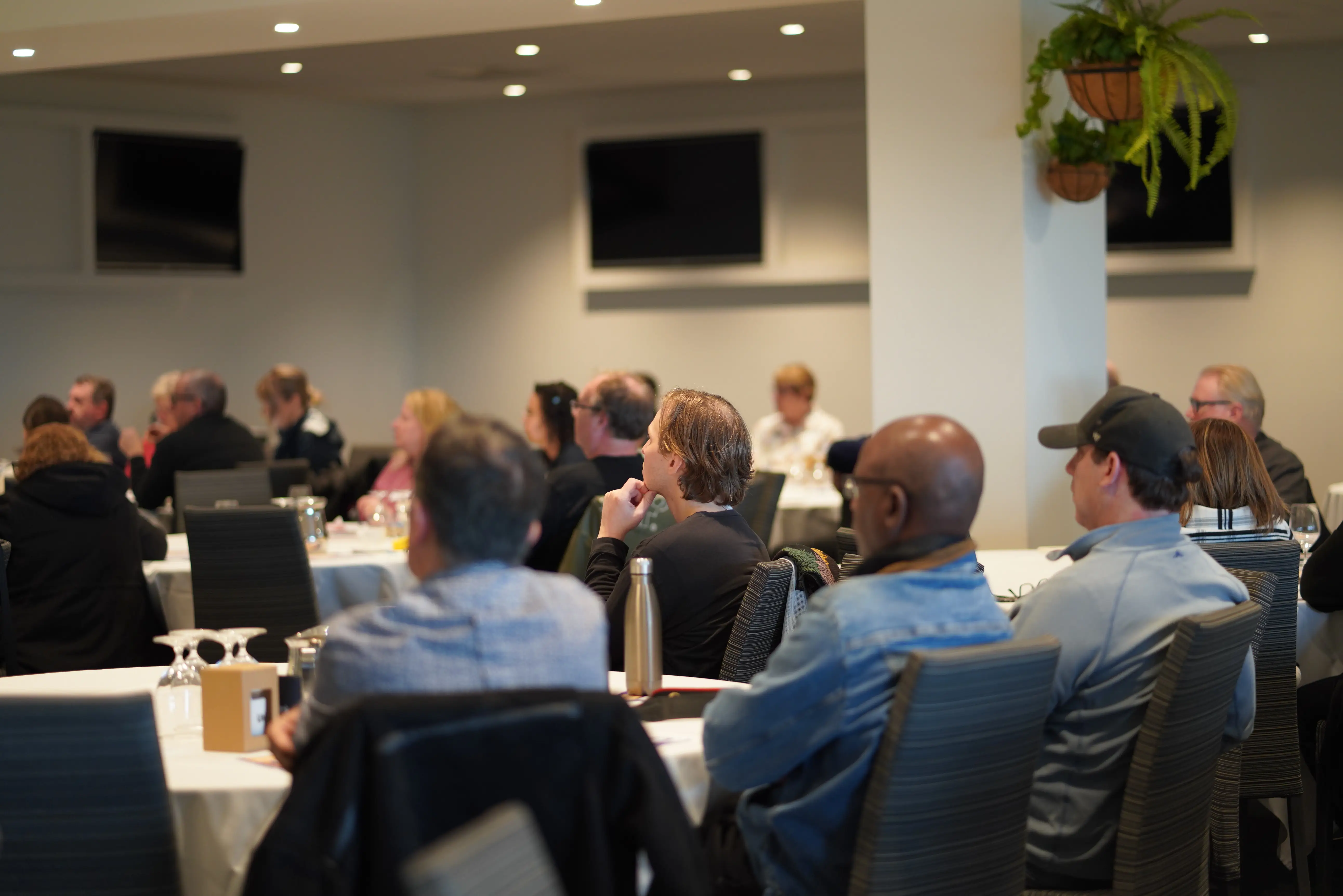 Photo of a conference room of HACSU disability worker union members watching a presenter.