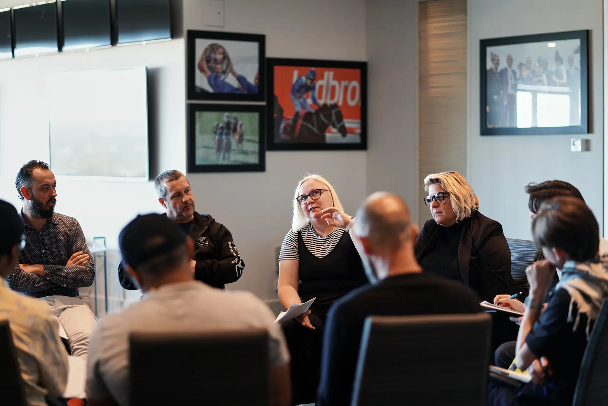 A group of HACSU mental health social workers discussing issues facing Victorian allied health workers.